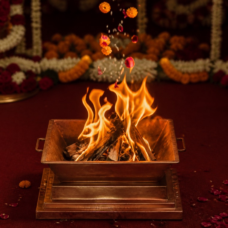 Traditional Hindu wedding havan kund with sacred fire and floral offerings